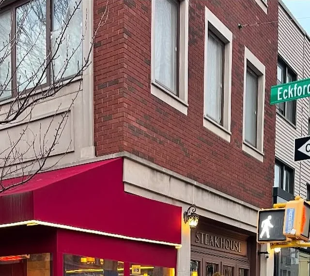 Red awning of Amber Steakhouse at Nassau Avenue and Eckford Street