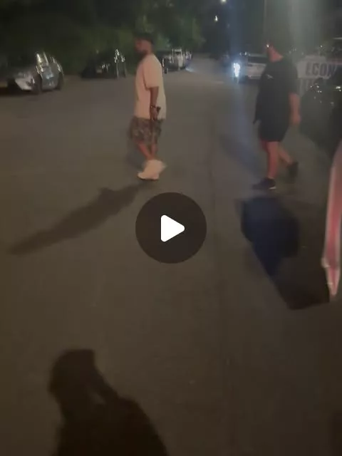 Guests walking along a residential street at night during a July 4th private event